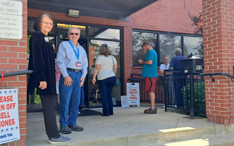 Megan Horn/The Clayton Tribune. Rabun Countians showed up to vote on Election Day as the line at the polls overflowed out the door and those registered waited to check in and vote at the Rabun County Elections Office Tuesday, May 21. Those casting their ballots did not see a long wait time. Above, pictured from left are poll workers Glenda Enloe and Rick Crouse.