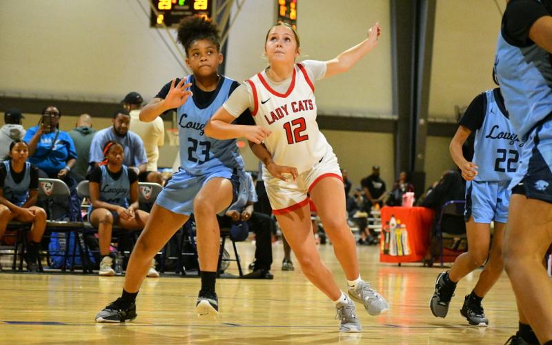 Wade Cheek/The Clayton Tribune. RCHS junior guard Conley Spivey battles for position to earn a rebound during the Lady Cats’ summer game against Lovejoy on Friday, June 14. at the LakePoint Sports complex in Atlanta.