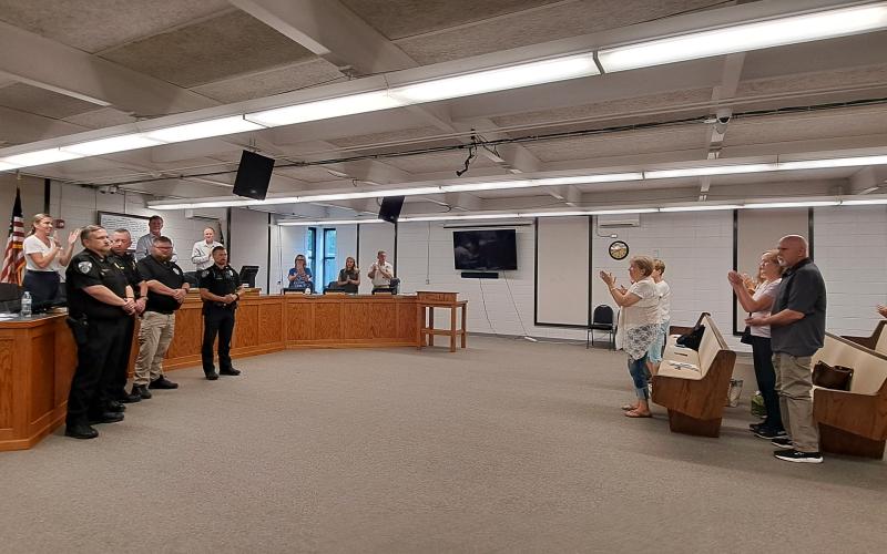 Megan Horn/The Clayton Tribune. Clayton Police Department Officers Investigator Matt Thomas, Assistant Chief John Grist, Sgt. Andy Beck, and Officer Justin Buchanan, receive a standing ovation during a special presentation at the June 18 Clayton City Council meeting for their heroic acts that saved an infant on March 5, 2024. Those actions will be recorded in the American Police Hall of Fame.