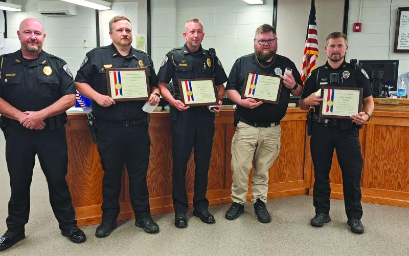 Megan Horn/The Clayton Tribune. Clayton Police Department Chief Andy Strait (from left) presents Investigator Matt Thomas, Assistant Chief John Grist, Sgt. Andy Beck, and Officer Justin Buchanan with awards and medals for their heroic actions and lifesaving efforts for an infant during a call March 5, 2024. The officers’ actions will be recorded in the American Police Hall of Fame.