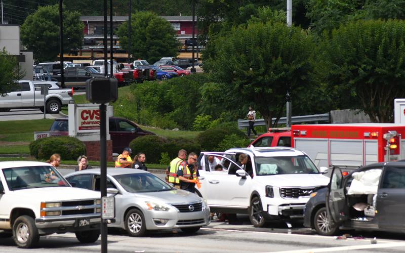 Enoch Autry/The Clayton Tribune. Clayton Police Department officers work the scene of a two-vehicle collision at the intersection of Ga. 15 and Chechero Street the morning of June 20. Minor injuries were reported with the crash.