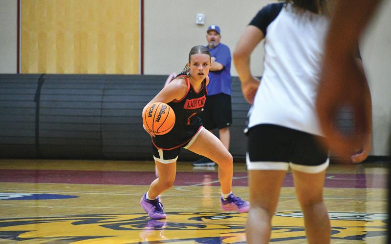Wade Cheek/The Clayton Tribune. RCHS sophomore Adelyn Thompson surveys the court for an open pass during the Rabun County girls basketball team’s game versus Ringgold at Emmanuel University on June 10. Thompson was a reliable target from three-point range and will be looking to let the three’s fly during this upcoming season.