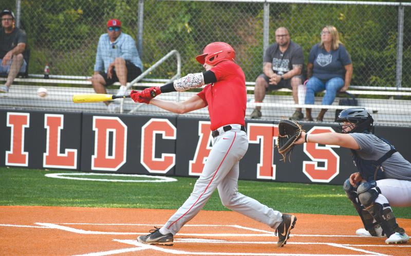 Wade Cheek/The Clayton Tribune. RCHS baseball senior Elvis Hunt lines a base hit into the outfield during the RCHS baseball team’s game against East Jackson on  Thursday, June 13.