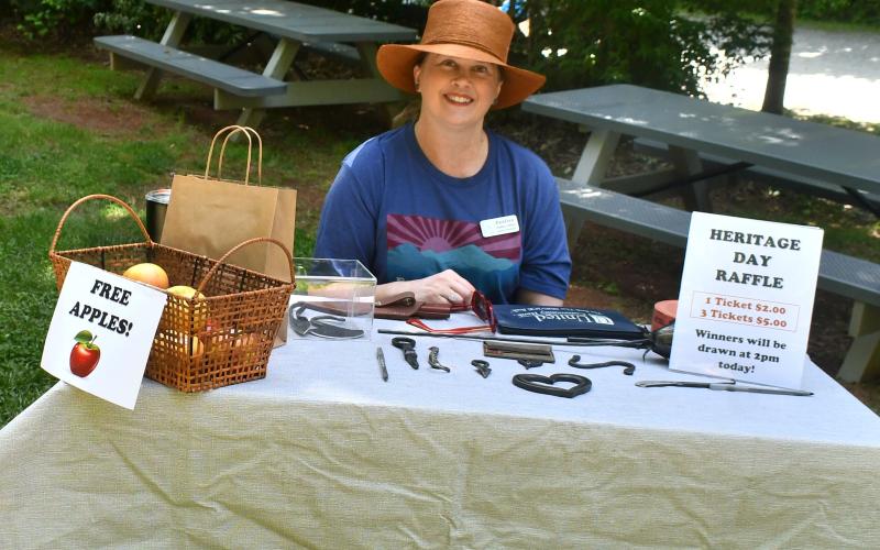 Megan Horn/The Clayton Tribune.  Jennifer Arbitter, vice-chair/vice-president of The Foxfire Fund, Inc. board of directors, sells raffle tickets during Foxfire’s Heritage Days event last weekend.