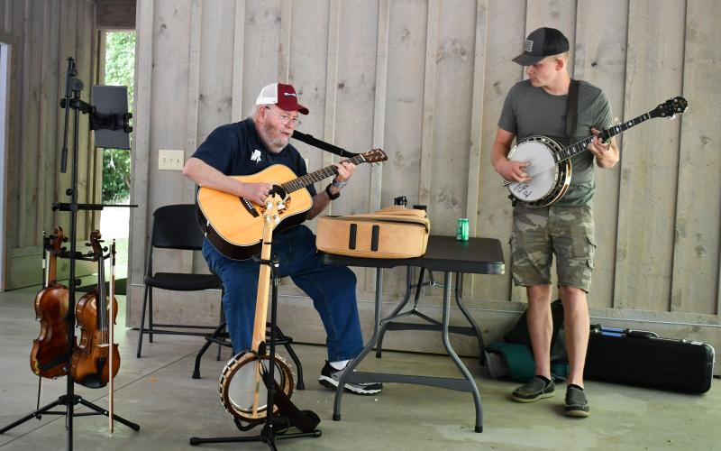 Megan Horn/The Clayton Tribune.  Musicians Tom Estes and Jake McCrackin entertain event-goers at the pavilions during Foxfire Heritage Days June 7 and 8 in Mountain City. Many people enjoyed lunch at the pavilion, catered by North Georgia Catering Company, while listening to music. The event marked the 50th anniversary of the start of the museum.