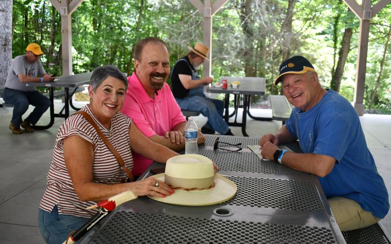 Megan Horn/The Clayton Tribune. Cindy Hamilton, Randy Hamilton and Jef Fincher enjoy music by Tom Estes and Jake McCrackin at the pavilions of the Foxfire Museum during the Heritage Days event June 7 and 8.