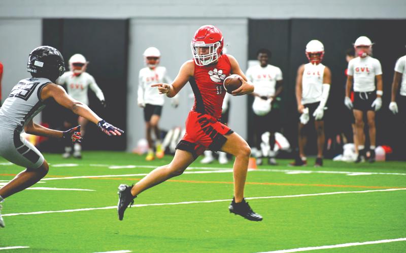 Wade Cheek/The Clayton Tribune. Rabun County football wide receiver Jake Payne speeds by an Alpharetta defender for a touchdown during a 7-on-7 camp at the University of Georgia on Thursday, June 20. The Wildcats played four games within the Bulldogs’ “House of Payne” indoor facility with a number of UGA football coaches and players watching.