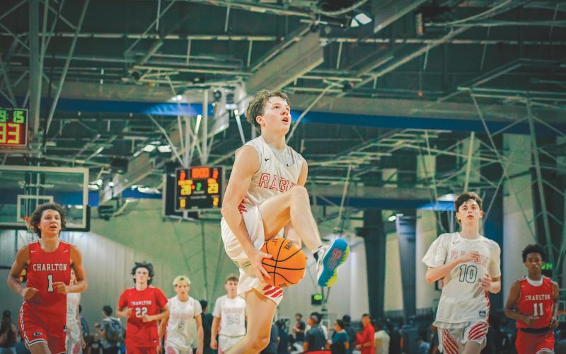 Wade Cheek/The Clayton Tribune. RCHS junior guard Huey Blalock goes between the legs for a fast-break layup during the Wildcats’ 29-point win over Charlton County at the LakePoint Sports Complex on Sunday, June 23. Blalock and the Wildcats finished this summer season 18-4.