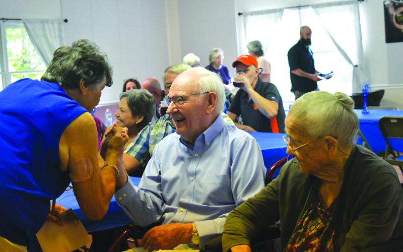 Enoch Autry/The Clayton Tribune. Otus Gibson (left) congratulates Ervin Chastain, who turned 101 on June 10 ,at a June 15 birthday celebration at Battle Branch Branch Baptist Church. Seated next Chastain is his sister-in-law Rose Chastain who will turn 100 on July 27.