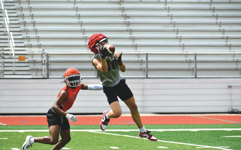 Wade Cheek/The Clayton Tribune. RCHS football senior Clayton Blalock makes an acrobatic catch during the Wildcats’ 7-on-7 session with Hart County on June 6. Blalock, a wide receiver, is looking to be one of the top receiving threats.