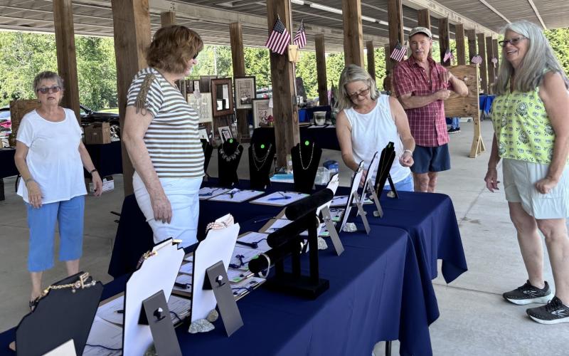 Photos courtesy of Rabun County Democrats. Lynn Roe, Karen Carroll, Melanie Vickers, and Richard and Janice Cochrane set up the silent auction at the June 15 Blue BBQ. Over 200 people attended the fundraising event of the Rabun County Democrats.