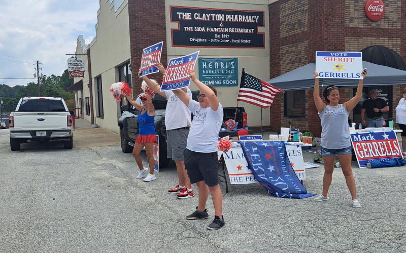 Megan Horn/The Clayton Tribune. Mark Gerrells supporters campaign and cheer on Main Street as passing vehicles honk on Election Day. Gerrells defeated incumbent Sheriff Chad Nichols in Tuesday’s Republican runoff 1,878 votes to 351.