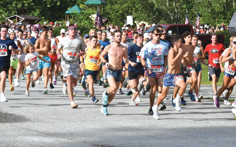 Wade Cheek/The Clayton Tribune. A record 1,564 participants take off during the beginning stages of the Lake Burton Fun Run. In the center, the eventual overall winner Nolan Weisdorfer of Holly, Mich.