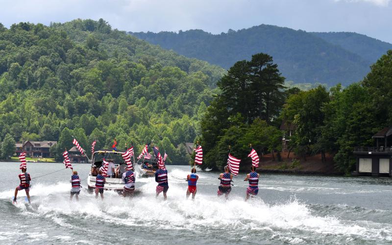 Enoch Autry/The Clayton Tribune. With the backdrop of the Northeast Georgia mountains, the Ski Patriots are pulled into a cove on Lake Burton on July 7.