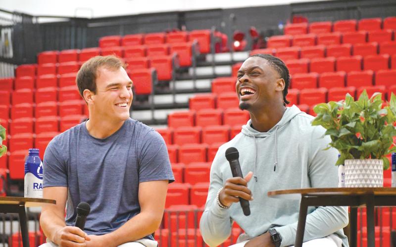 Wade Cheek/The Clayton Tribune. University of Georgia football teammates Gunner Stockton and Malaki Starks share a laugh during last Sunday’s Night of Champions as the two shared their testimonies alongside former RCHS standout and current Atlanta Falcon tight end Charlie Woerner.