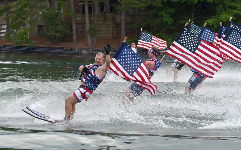 Enoch Autry/The Clayton Tribune.  Veteran Ski Patriot member Bobby Lanier waves during the final part of the skiers’ annual 27-mile journey around Lake Burton. The Ski Patriots’ performance is one of the most popular activities of each Independence Day.