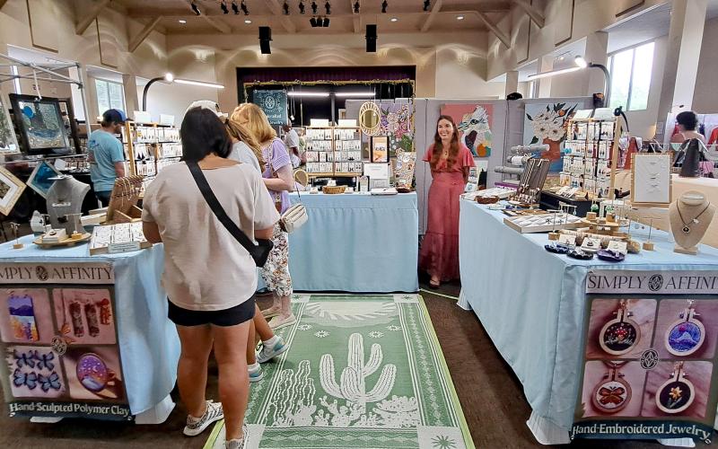 Megan Horn/The Clayton Tribune. Evie Somaji Kitchens showcases her handmade jewelry during the 2024 Painted Fern Art Festival last weekend. Below: Submitted. At the 2024 Painted Fern Art Festival, Sean and Ebony Wilson (left) were the Producers’ Choice Award winners for Best Booth with their woodworking. Sharon Mumbi (right) was chosen by show visitors and awarded the Peoples’ Choice for Best in Show with her mixed fiber-leather.
