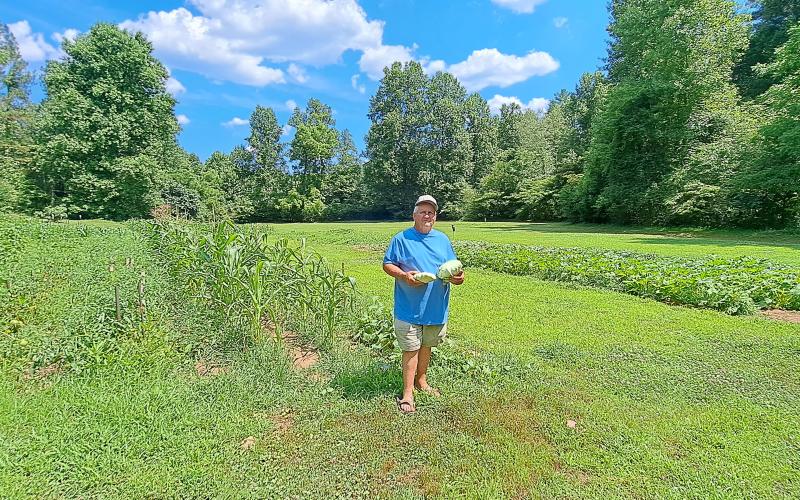Megan Horn/The Clayton Tribune. Joey Davenport displays some of the vegetables he grew out of his local garden.