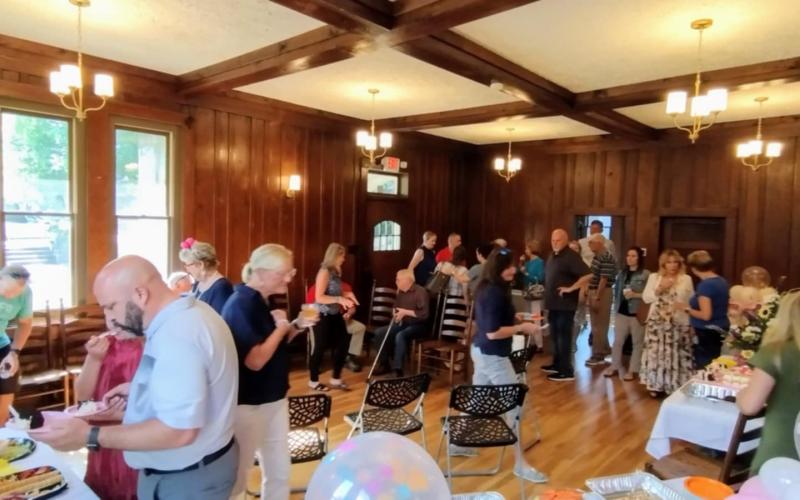 Photo courtesy of Conner Horn. There was a large crowd at The Rock House in Clayton July 15 for Rhonda Lunsford’s retirement from the City of Clayton after 14 years. Many people shared stories about Lunsford and congratulated her. Below: Clayton City Manager Trudy Crunkleton, left, and Mayor Kurt Cannon, right, present Rhonda Lunsford with a gift and congratulate her on her retirement from the City of Clayton after 14 years during Tuesday’s city council meeting.