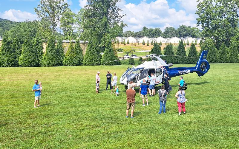 Megan Horn/The Clayton Tribune.  Children and families got the opportunity to see an AirLife Georgia helicopter land and take off, as well as meet first responders and explore inside the aircraft. Below: James Reddy, 4, and Jones Reddy, 2, enjoy their time climbing into the driver’s seat of this 1960 Fiat Multipla presented by Capital City Home Loans at the Habitat for Humanity Touch-A-Truck event.