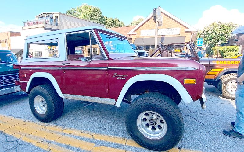 Megan Horn/The Clayton Tribune. Conner Horn checks out this Bronco 302, which was one of many Classic vehicles that cruised in at the block party.