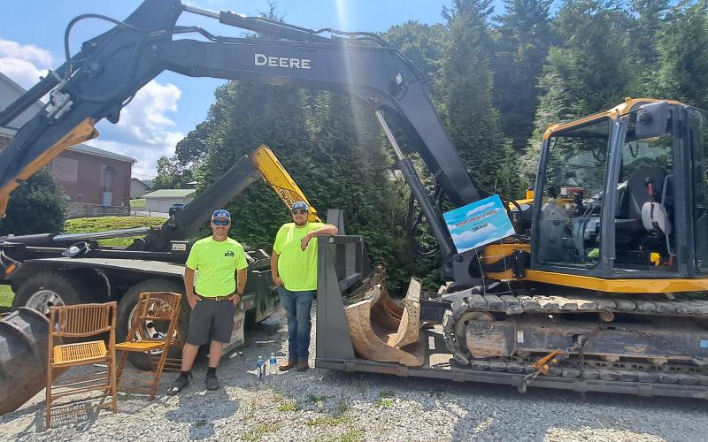 Megan Horn/The Clayton Tribune. Bryce Shackleford and James Jones engaged with kids during the Habitat for Humanity of Rabun County Touch-A-Truck event with this Trackhoe presented by Bryson Grading &amp; Paving. Below: James Reddy, 4, and Jones Reddy, 2, enjoy their time climbing into the driver’s seat of this 1960 Fiat Multipla presented by Capital City Home Loans at the Habitat for Humanity Touch-A-Truck event.