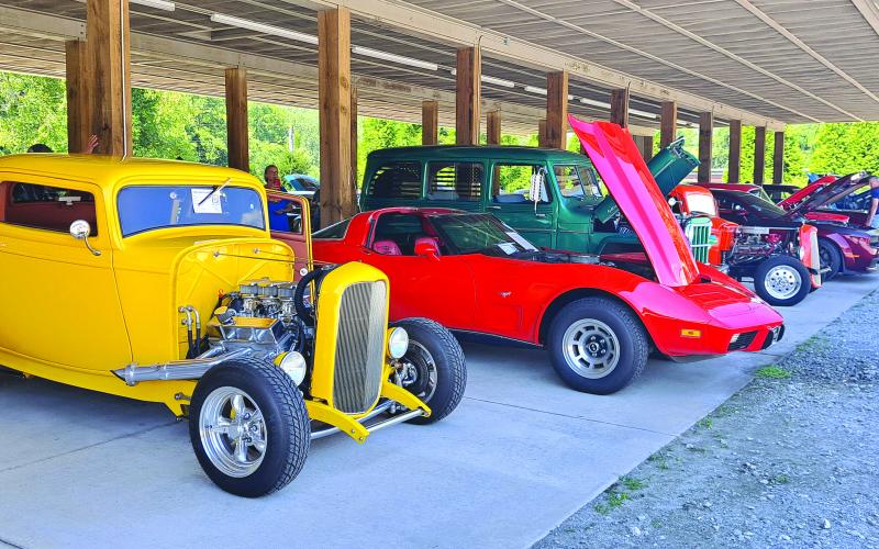 Megan Horn/The Clayton Tribune. There were a variety of cars featured at the Pharoah’s Car Club Rockin’ Mountain Motor Show on Saturday, Aug. 17. Pictured in the forefront are a yellow 1932 Ford Coupe with a 350 engine owned by Bob Cundari, left; and a red 1978 Chevy Corvette with 30,000 miles owned by Phil DeTore.