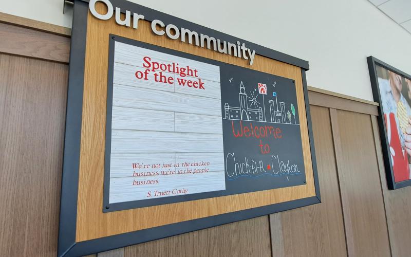 Megan Horn/The Clayton Tribune. The spotlight of the week welcomes customers to Chick-fil-A. Below: Those who order from the Chick-fil-A mobile app can go through the right “mobile-thru” lane at the restaurant and scan a QR code to obtain their order.