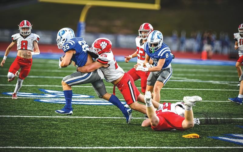 Wade Cheek/The Clayton Tribune. RCHS senior defensive end Tucker Buchanan drags Fannin County running back Carson Calihan to the turf for a tackle during Rabun County’s road 28-7 loss to Fannin County on Aug. 23.
