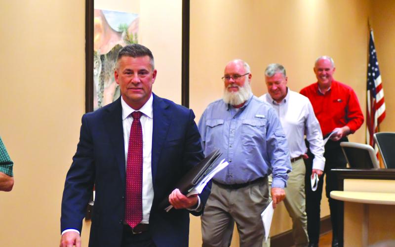 Enoch Autry/The Clayton Tribune. New superintendent Steven Cole makes his way to the Aug. 22 executive session as he is followed by school board members Vice Chair Mark Beck, Allyn Stockton and Rick Story.