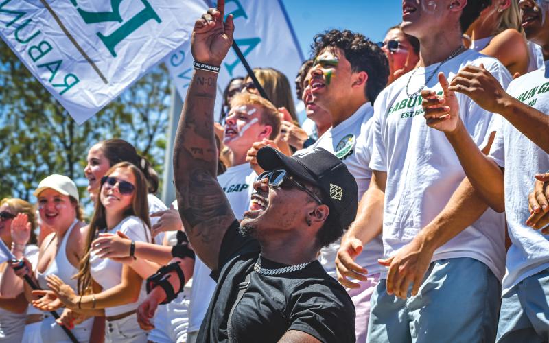Wade Cheek/The Clayton Tribune. Social media personality and United States Football League kicker “Deestroying” cheers on the Rabun Gap football team with the Eagle student section before Rabun Gap’s game versus Baylor School on Aug. 25.