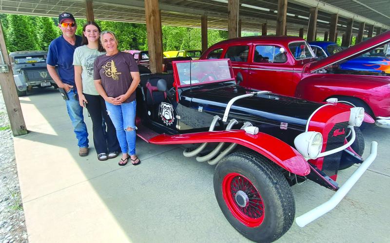 Megan Horn/The Clayton Tribune. It was easy to find Georgia Bulldog fans at last weekend’s Pharoah’s Car Club Rockin’ Mountain Motor Show. Pictured with this 1929 Mercedes Gazelle Replica with a 4-cylinder engine is car owner Hank Stone with Georgi (a.k.a. PUD) and Paytn.