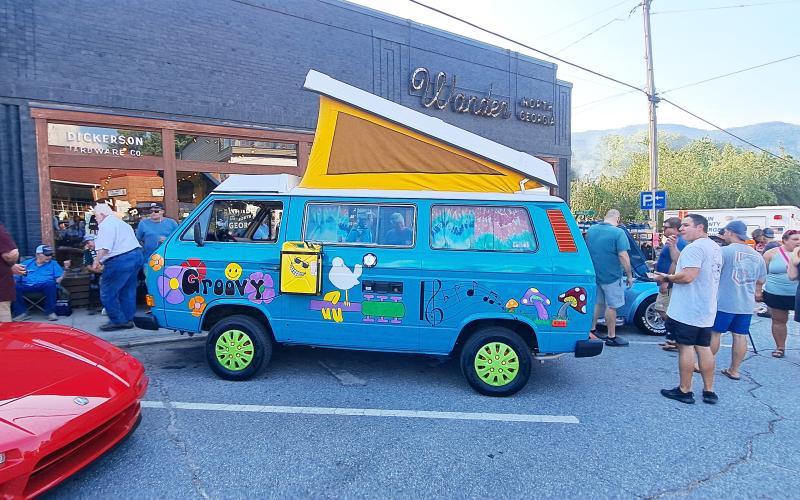 Megan Horn/The Clayton Tribune. This blue Volkswagen bus with bright artwork and the word “Groovy” was one of the 135-plus unique and classic vehicles that was showcased at last weekend’s block party in downtown Clayton.
