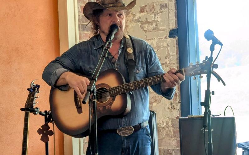 Debbie Martin/The Clayton Tribune. Tom Proctor performs at Blue Hound Barbeque in Dillard on July 19.