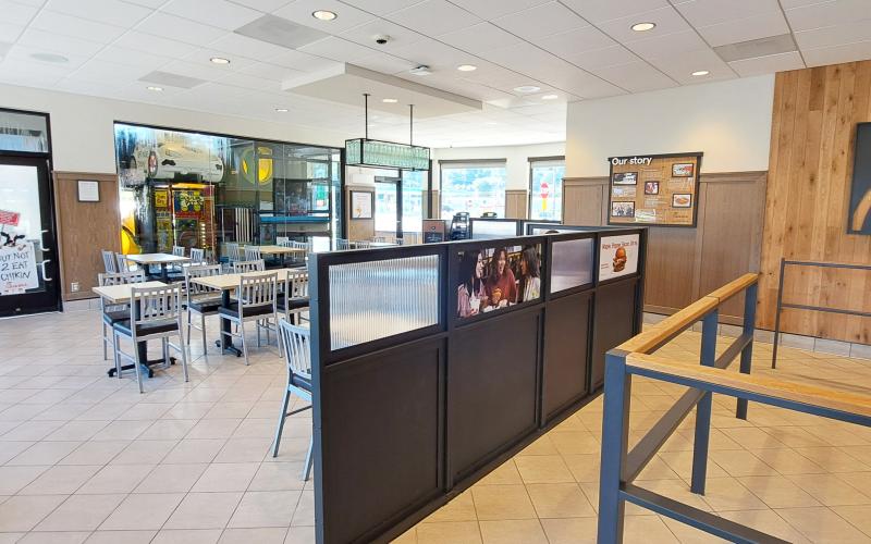 Megan Horn/The Clayton Tribune.  The inside dining area has a more up-to-date look after the remodel. Below: Those who order from the Chick-fil-A mobile app can go through the right “mobile-thru” lane at the restaurant and scan a QR code to obtain their order.