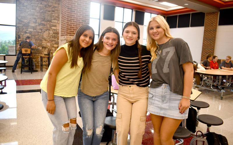 Megan Horn/The Clayton Tribune. Hayden Bass, 11th grade; Elexa English, 10th grade; Emma Krivsky, 10th grade; and Kate Church, 10th grade, are all smiles and looking glamorous on their first day of school at Rabun County High School on Aug. 6. Below: School Resource Deputy Sgt. Lindsey Owens directs school traffic on the first day Tuesday, Aug. 6.