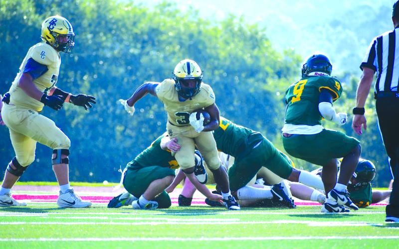 Wade Cheek/The Clayton Tribune. Rabun Gap’s senior running back Anthony Quinn Jr. breaks through the line during the Eagles’ win over AC Reynolds in the Aug. 9 jamboree at Rabun County High School. The Eagles will head to Georgia Southern University in Statesboro to play Benedictine to begin their season on Saturday, Aug. 17.