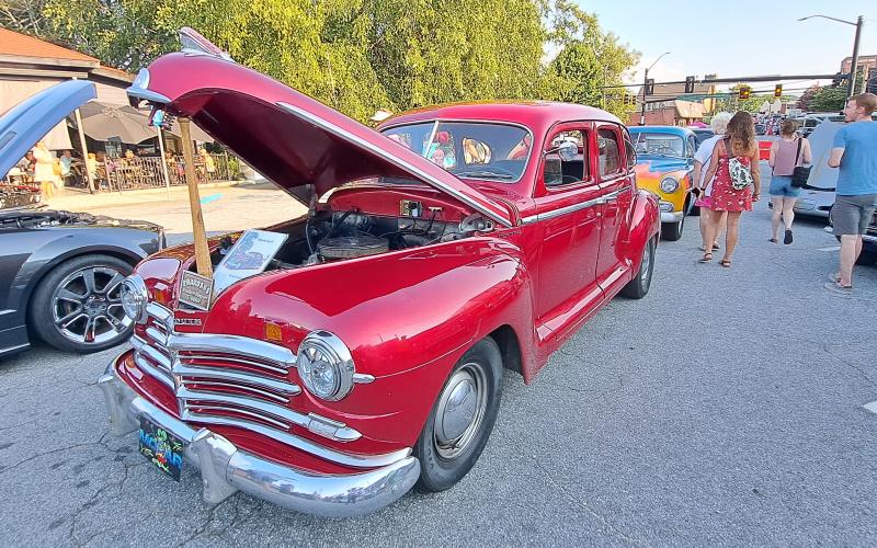 Megan Horn/The Clayton Tribune. This red classic owned by Cody Whitmire was showcased at the Downtown Clayton Block Party with a sign that read “Pharoahs Eastern Region Truckin’.”