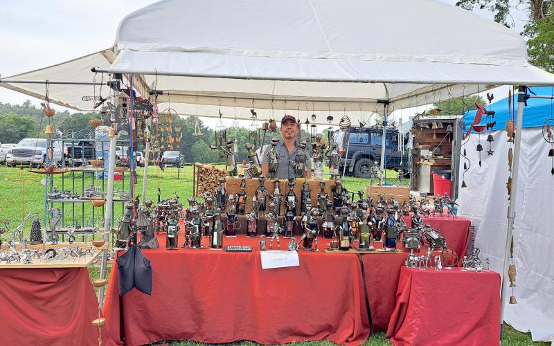 Megan Horn/The Clayton Tribune.  Tarik Berbey with his business “The tin man and friends” out of Atlanta, Ga., makes works of art out of recycled materials such as spark plugs, bike chains, nuts and bolts and more. Berbey displays his creations during the 27th Dillard Bluegrass Benefit Festival Aug. 2 and 3.