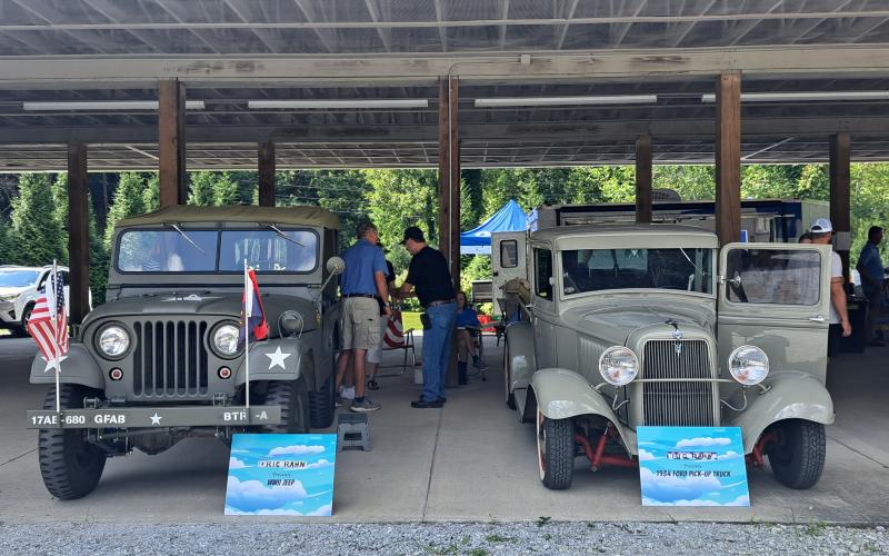 Megan Horn/The Clayton Tribune. Some unique vehicles were showcased during the Habitat for Humanity of Rabun County Touch-A-Truck event. Ric Rahn presented this WWII Jeep on the left and a 1934 Ford pickup truck on the right. Below: James Reddy, 4, and Jones Reddy, 2, enjoy their time climbing into the driver’s seat of this 1960 Fiat Multipla presented by Capital City Home Loans at the Habitat for Humanity Touch-A-Truck event.