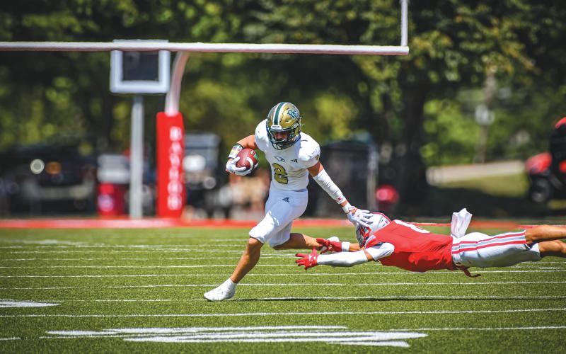 Wade Cheek/The Clayton Tribune. Junior Eagles receiver Walker Bryson shedded a tackler to find an open sideline to score a 48-yard touchdown against Baylor School on Sunday, Aug. 25. The third-quarter score was the second and final for the Eagles as the Red Raiders won 21-14.