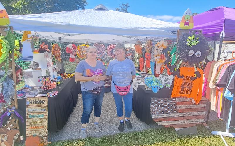 Megan Horn/The Clayton Tribune. This year’s Tiger Corn Festival featured three-times the vendors selling their unique and artistic creations. Janene Bostedt and Susan Imperatore display their creations at the festival Saturday, Sept. 21.