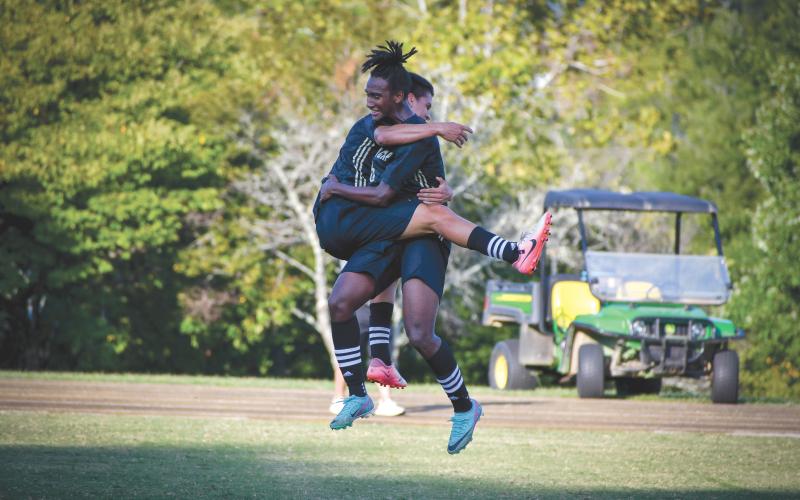 Wade Cheek/The Clayton Tribune. RGNS junior Daniel Salazar (left) and junior Tau Lamsee jump to celebrate a late goal in Rabun Gap’s 3-1 win over conference opponent Asheville Christian School on Tuesday, Sept. 10.