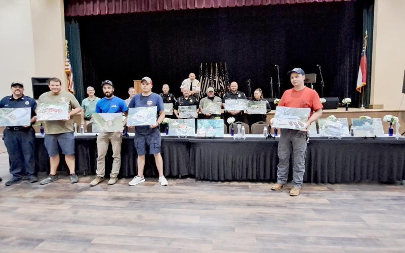Megan Horn/The Clayton Tribune. During the program, first responders were presented with gifts which included aerial photos of public safety stations taken by local photographer Scott Poss.