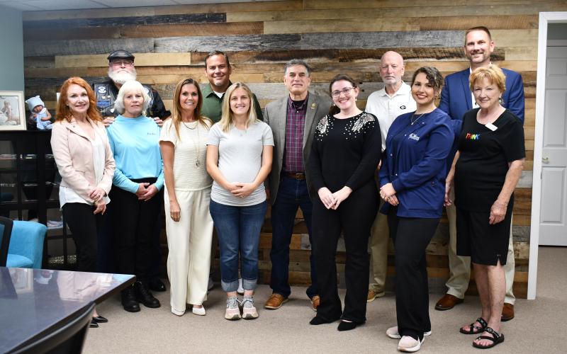 Megan Horn/The Clayton Tribune.  Pictured are Rotary Club of Clayton President Sheryl Webster, volunteer Ronda Lancaster; volunteer Mark Lancaster; Choices Executive Director Carla Wright; Church of the Mountains Pastor Adam Wright; volunteer Ashley Ownbey; Clyde; Administrative Coordinator Elaina Hill-Hooker; St. Helena Catholic Church Representative Matt Mitcham; Nurse Manager Kayla Scott, LPN; Volunteer Lynda Dann; and Volunteer David Berend.