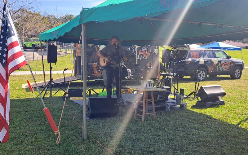 Megan Horn/The Clayton Tribune. Actor and musician Tom Proctor performs live music during the Tiger Corn Festival last Saturday. He sang original songs such as “In Hollywood” as well as other songs written for his wife, Concha.