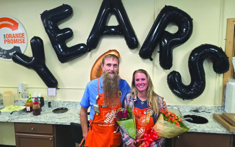 Enoch Autry/The Clayton Tribune. The Home Depot Assistant Manager Seth Caudell and InFocus Captain Shanda Carman help lead the associates in Clayon.