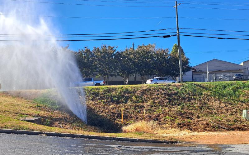 Megan Horn/The Clayton Tribune. An estimated 50,000 gallons of water was released after a four inch plastic water main developed a leak at Plaza Way on Monday afternoon. It was caused by the large amount of water received during Hurricane Helene, according to officials.