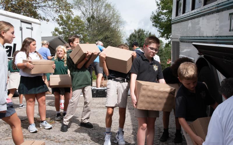 Submitted photo. Fifth graders load water onto TFS bus at Get Real Ministries before taking it to the Habersham Airport to be delivered to Western Carolina for those impacted by Hurricane Helene
