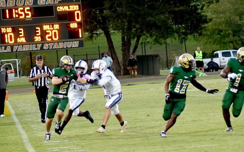 Enoch Autry/The Clayton Tribune. Rabun Gap-Nacoochee’s Walker Bryson takes it down the sideline on the opening kickoff to put the Eagles up 7-0 in their Homecoming win.
